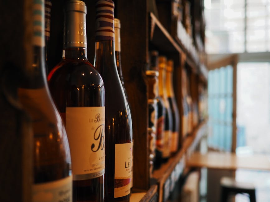 Assorted French wine bottles on wooden shelves in a shop