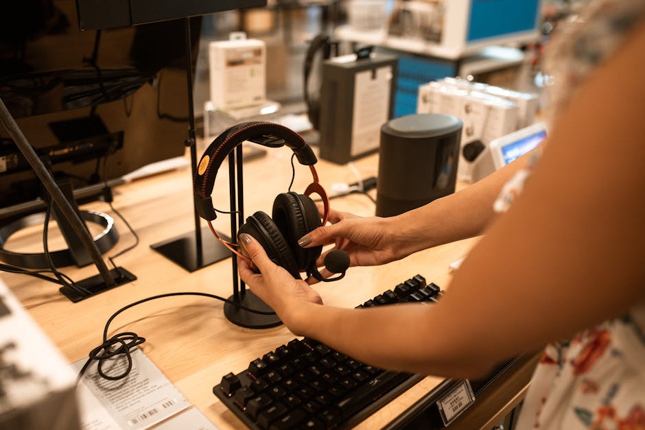 assorted new earbuds and headphones on display in electronics store
