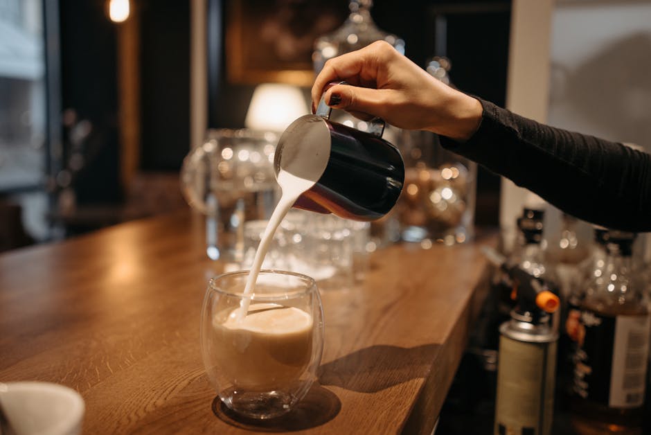barista pouring latte art in cozy polish cafe