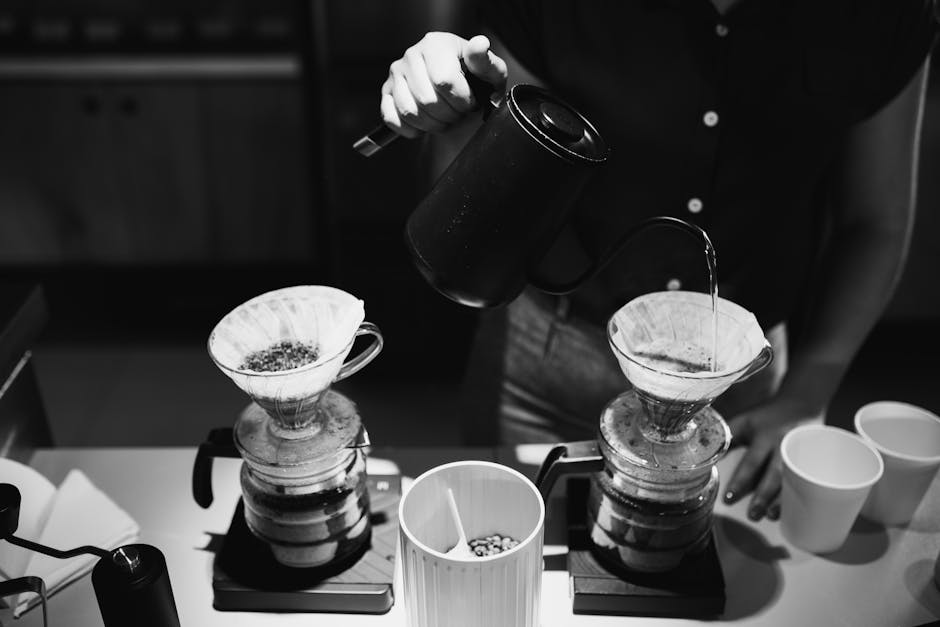 Barista preparing pour over coffee in artisanal cafe