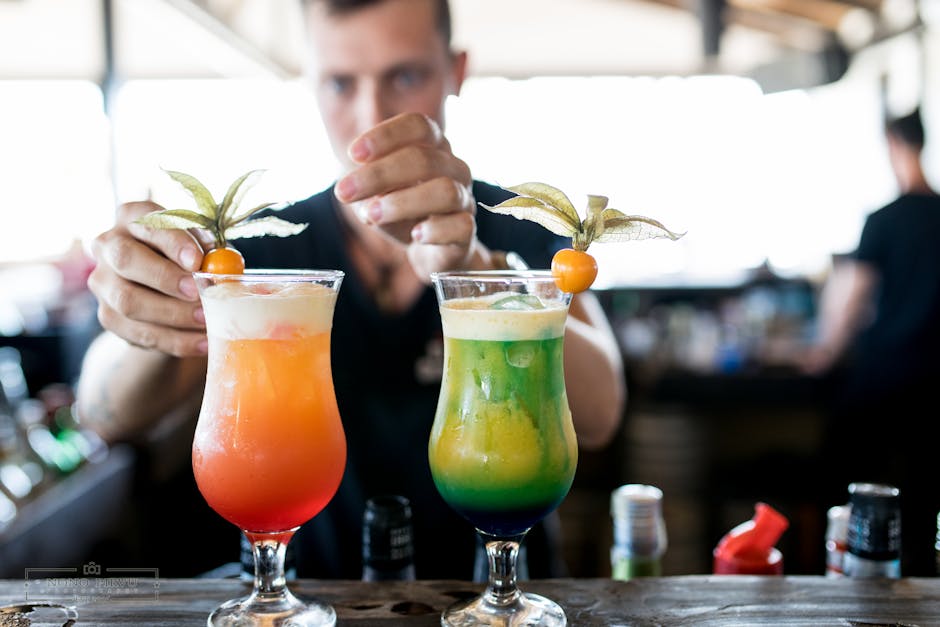  bartender preparing colorful mocktail cocktail
