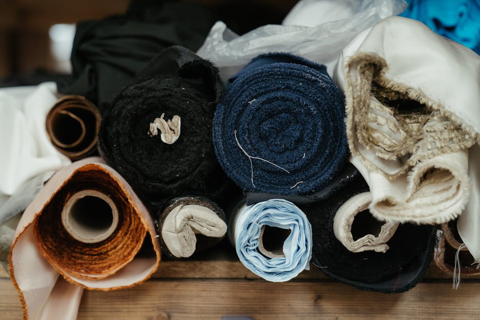 Colorful sustainable fabric rolls arranged in textile workshop