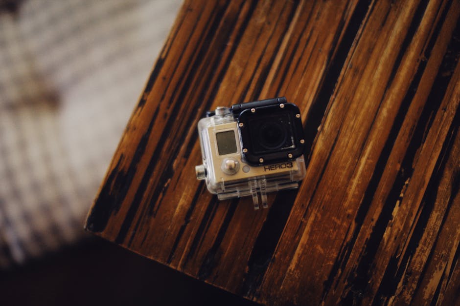compact action camera near tropical waterfall