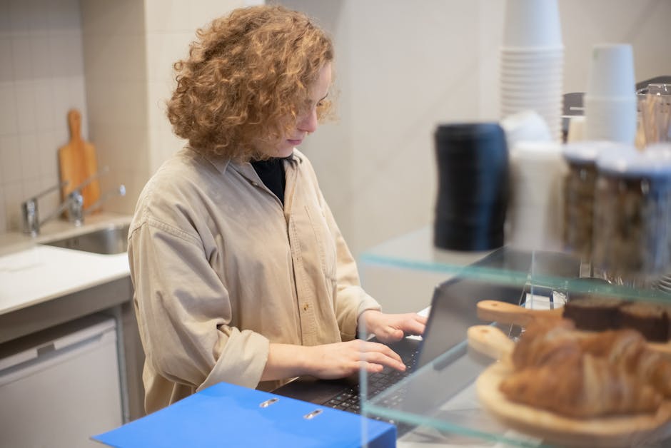 customer working on laptop in cozy coffee shop