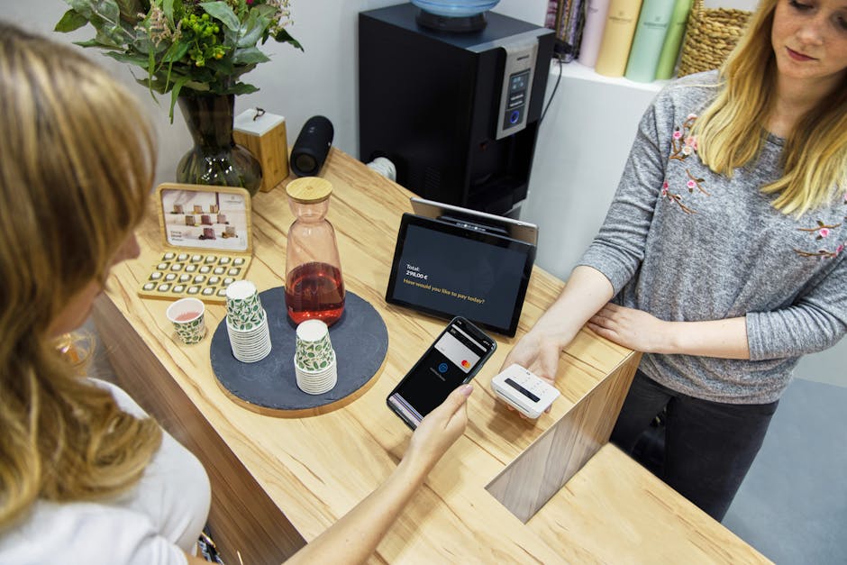 digital payment terminal showing QR code at small shop