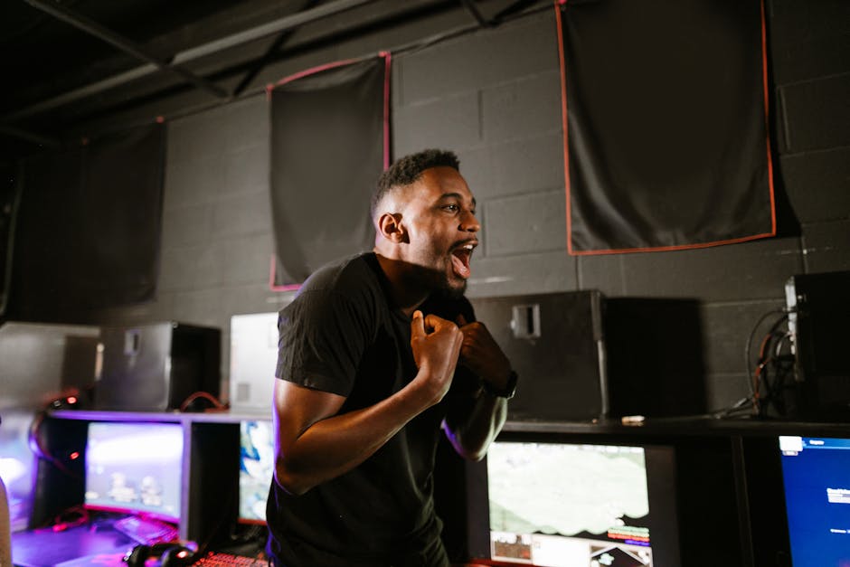 Excited young man playing video games on computer