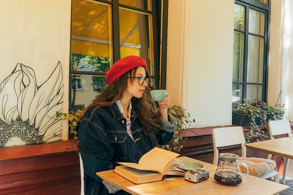 female traveler reading at Berlin cafe window seat