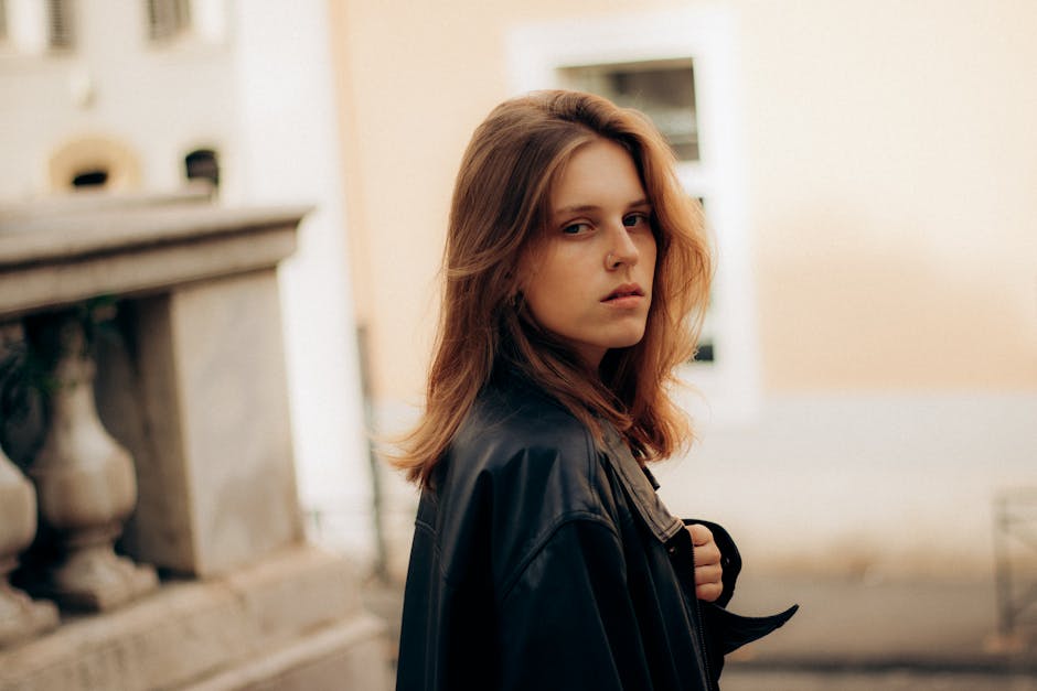 French fashion model in bordeaux leather jacket on street