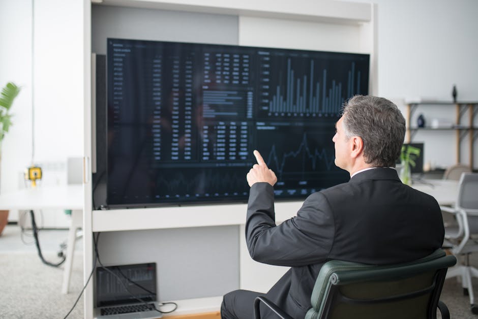 Modern office meeting with data screens