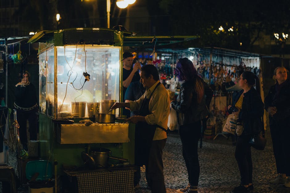 Night market with Brazilian street food stalls and people