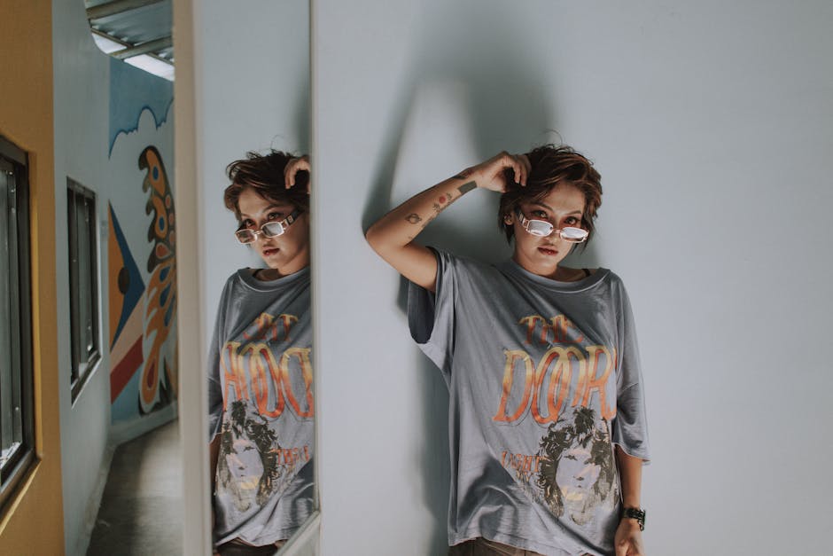 person styling oversized outfit in front of mirror