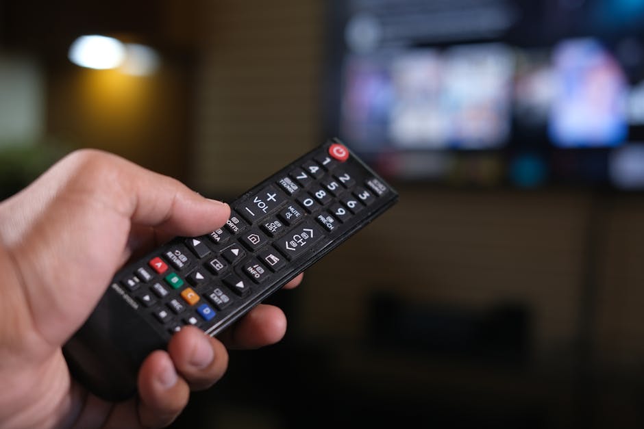 person testing television remote control in store