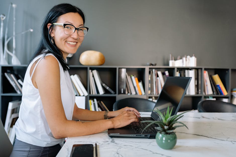person using laptop in modern office