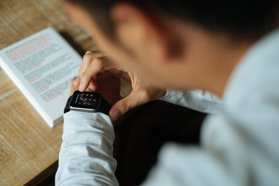 person wearing smartwatch checking notifications outdoors