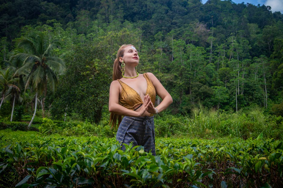 relaxed woman meditating in a lush green jungle setting