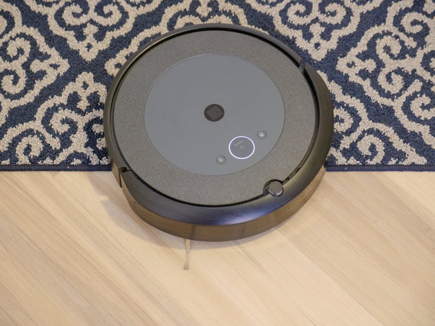 robot vacuum cleaner on carpet near furniture