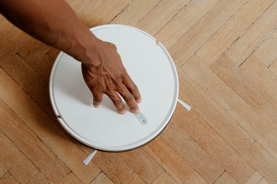 robot vacuum cleaner on wooden floor in bright apartment
