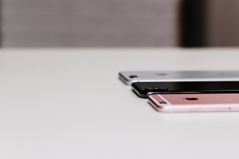 row of modern smartphones displayed side by side