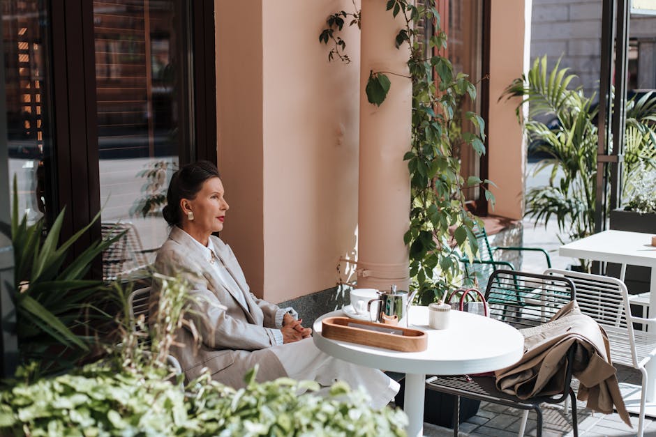 solo woman sitting at cafe terrace Spain