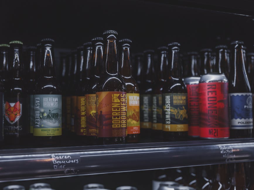 variety of craft beer bottles on wooden shelf in specialty store