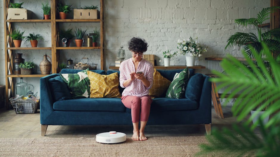 woman controlling home devices with smartphone in cozy home