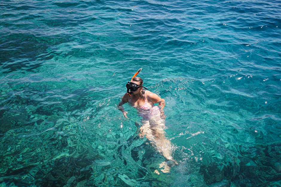woman snorkeling in clear tropical water