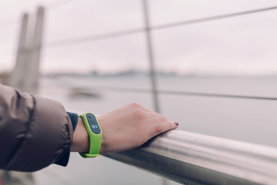 woman wearing smartwatch exercising outdoors