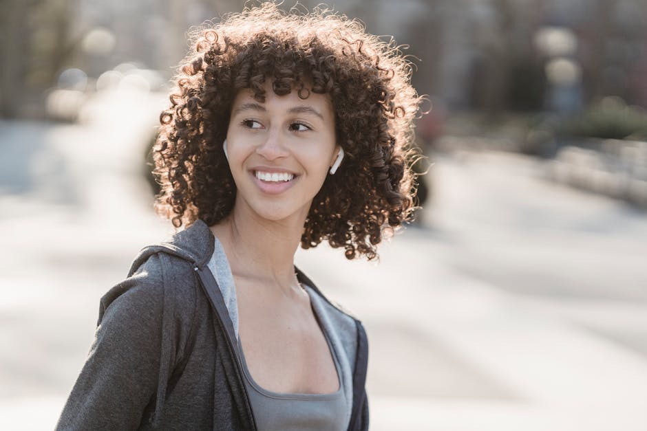 woman wearing white wireless earbuds smiling
