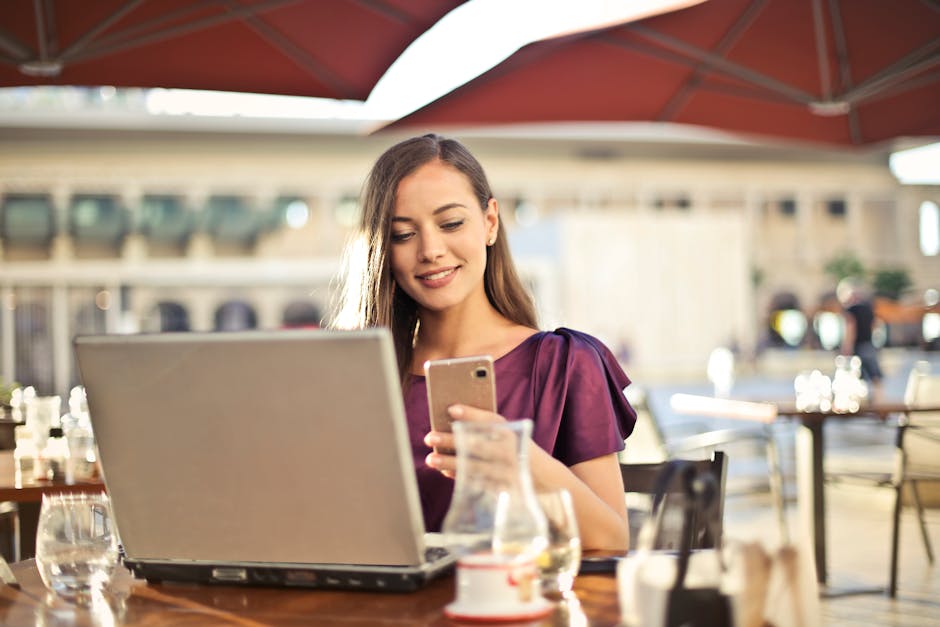 Young Brazilian woman freelancer managing social media on laptop at cafe