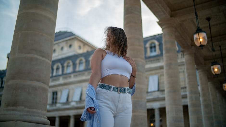 young woman in paris wearing low-rise jeans and crop top